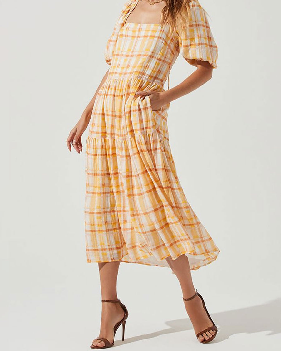 model wearing yellow and orange puff sleeve plaid midi dress 