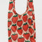 big baggu in blush pink with large red strawberry pattern