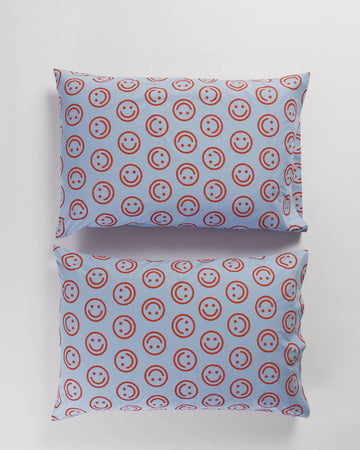 set of 2 pillows in cornflower with red smiley faces
