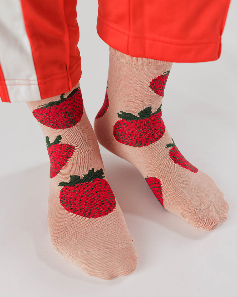 model wearing baggu crew socks with pink ground and strawberry print