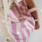 model carrying pink and white vertical stripe baggu horizontal duck bag