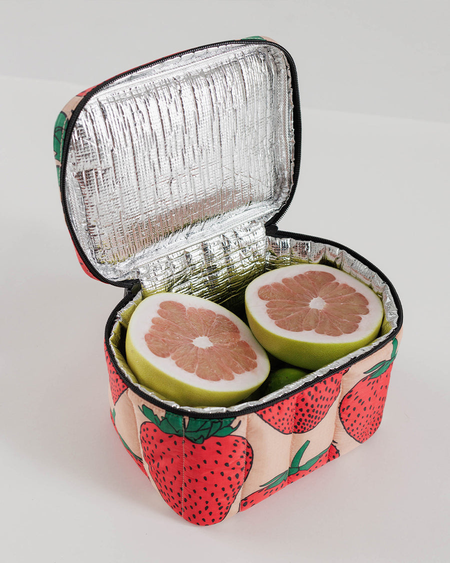 baggu puffy lunch bag with pink ground and all over strawberry print filled with fruit