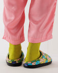 model wearing blue, pink, yellow and green puffy slippers