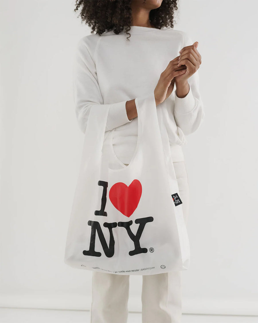 model holding white standard baggu with traditional 'I love NY' graphic