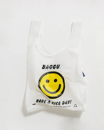white standard baggu with yellow smiley and 'baggu- have a nice day!' text