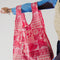 model holding standard baggu with hot pink ground and  all over print