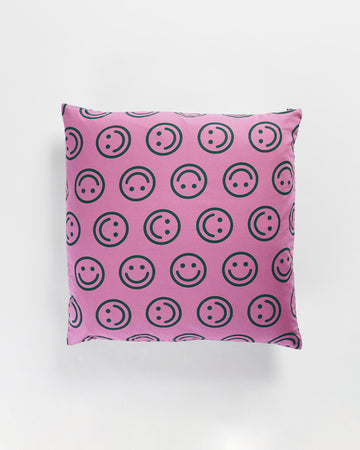 two-sided throw pillow in pink and forest green smiley faces