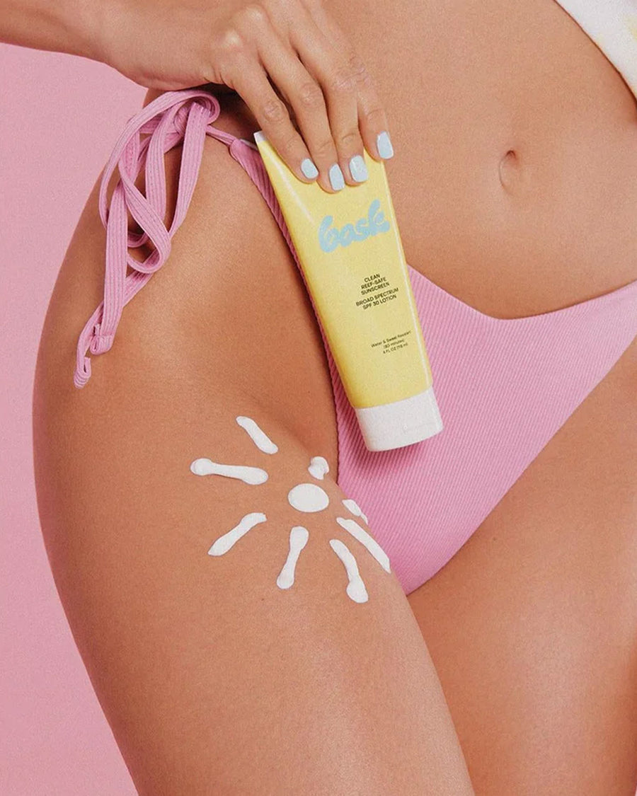 model holding clean reef-safe 30 spf sunscreen