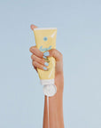 model squeezing tube of clean reef-safe 30 spf sunscreen