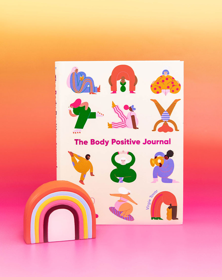 editorial image of the body positive journal by virgie tovar and rainbow de-stress ball