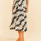 model wearing black and white floral abstract midi skirt with waist tie