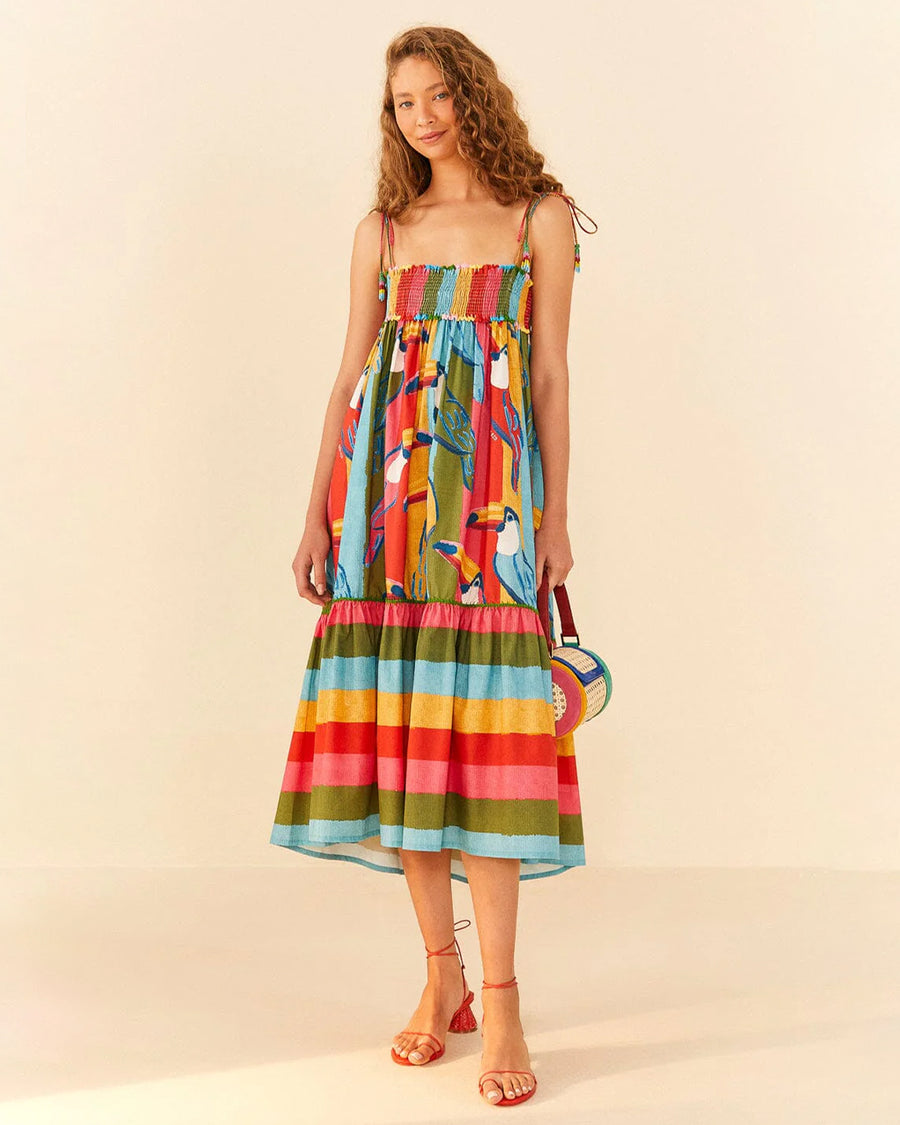 model wearing multicolor stripe midi dress with smocked bodice and fun toucan print