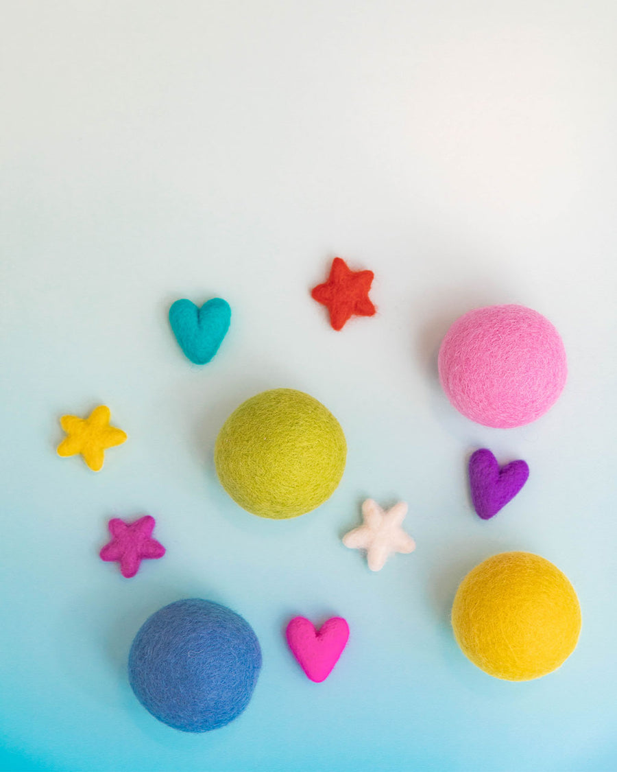 editorial image of wool dryer balls and shaped eco air fresheners in various colors