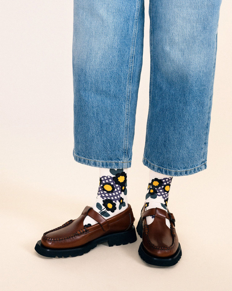 model wearing ivory crew socks with vintage blue and black flower design