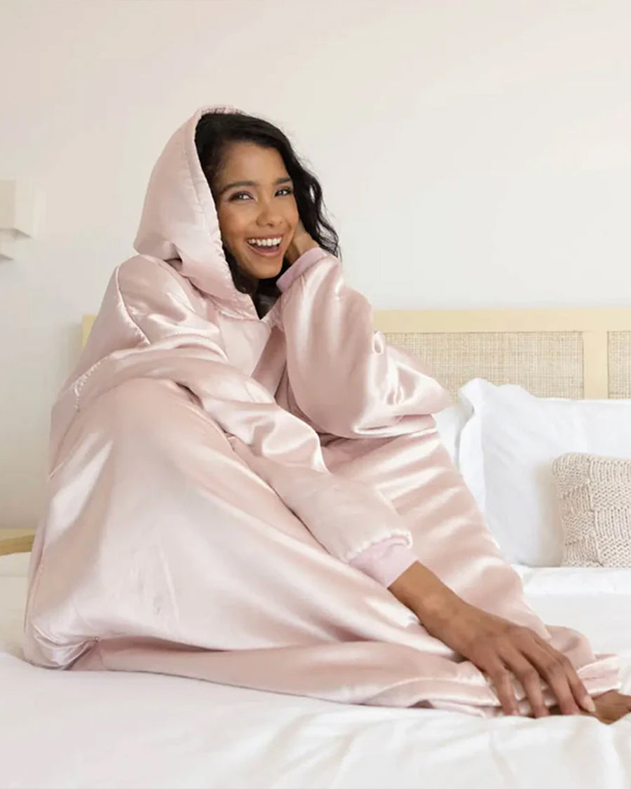 model snuggled up in blush satin oversized hoodie