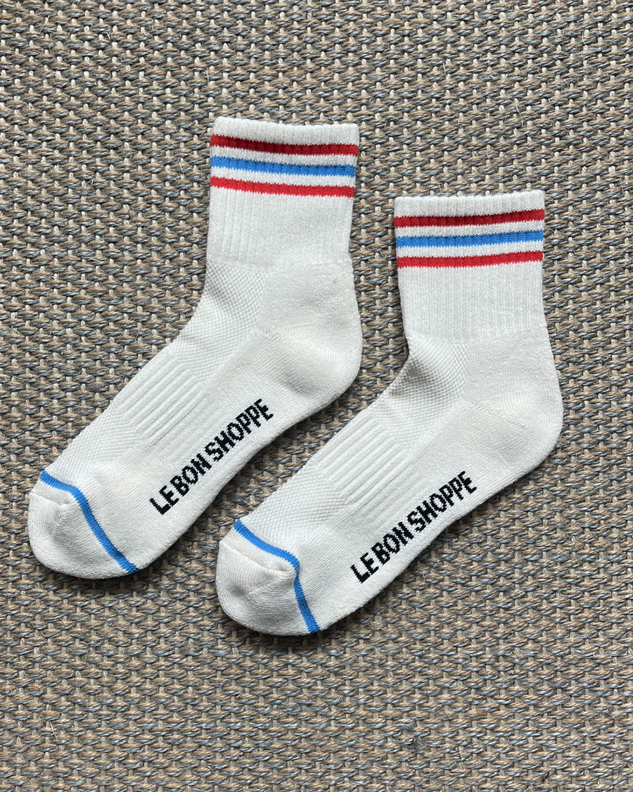 pair of white socks with red and blue stripe accents