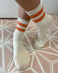 model wearing orange stripe varsity socks