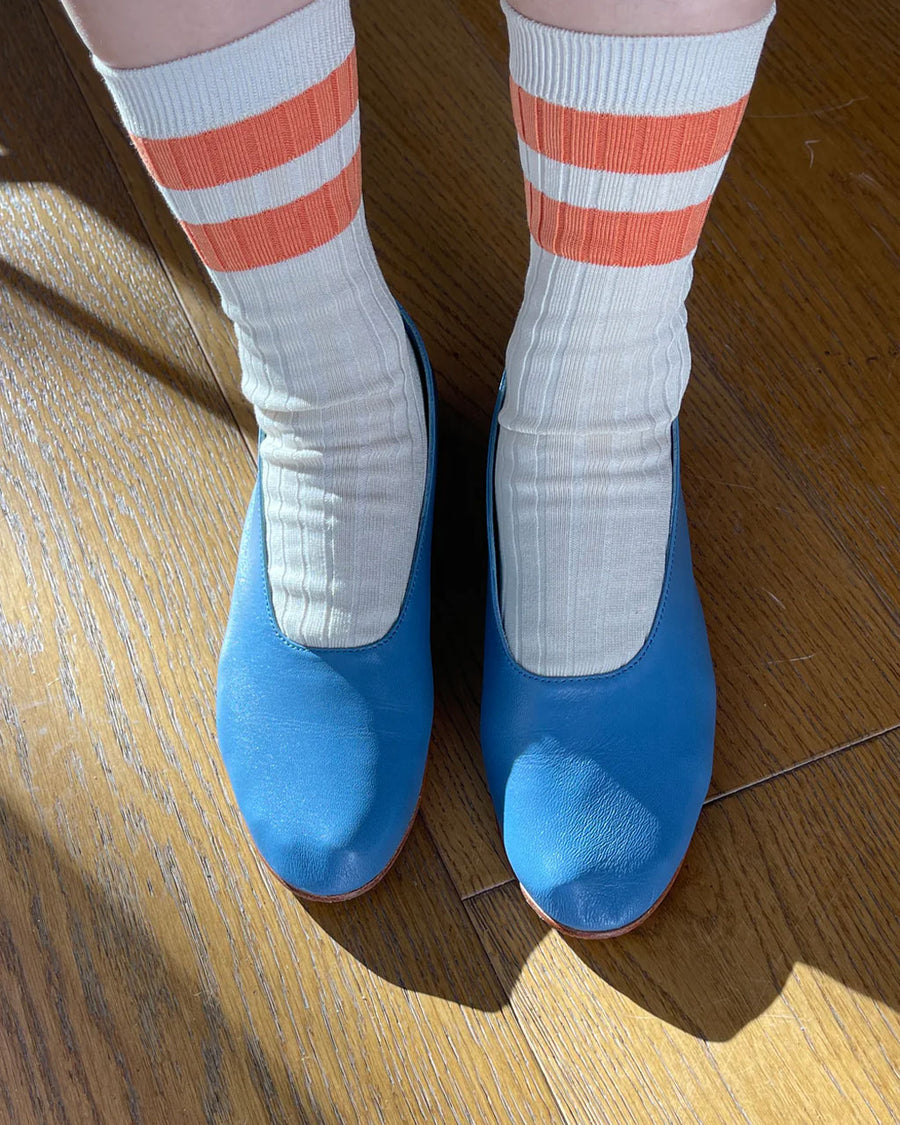 model wearing orange stripe varsity socks
