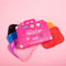 editorial image of set of 7 multicolor makeup eraser clothes and hot pink box shaped like a suitcase
