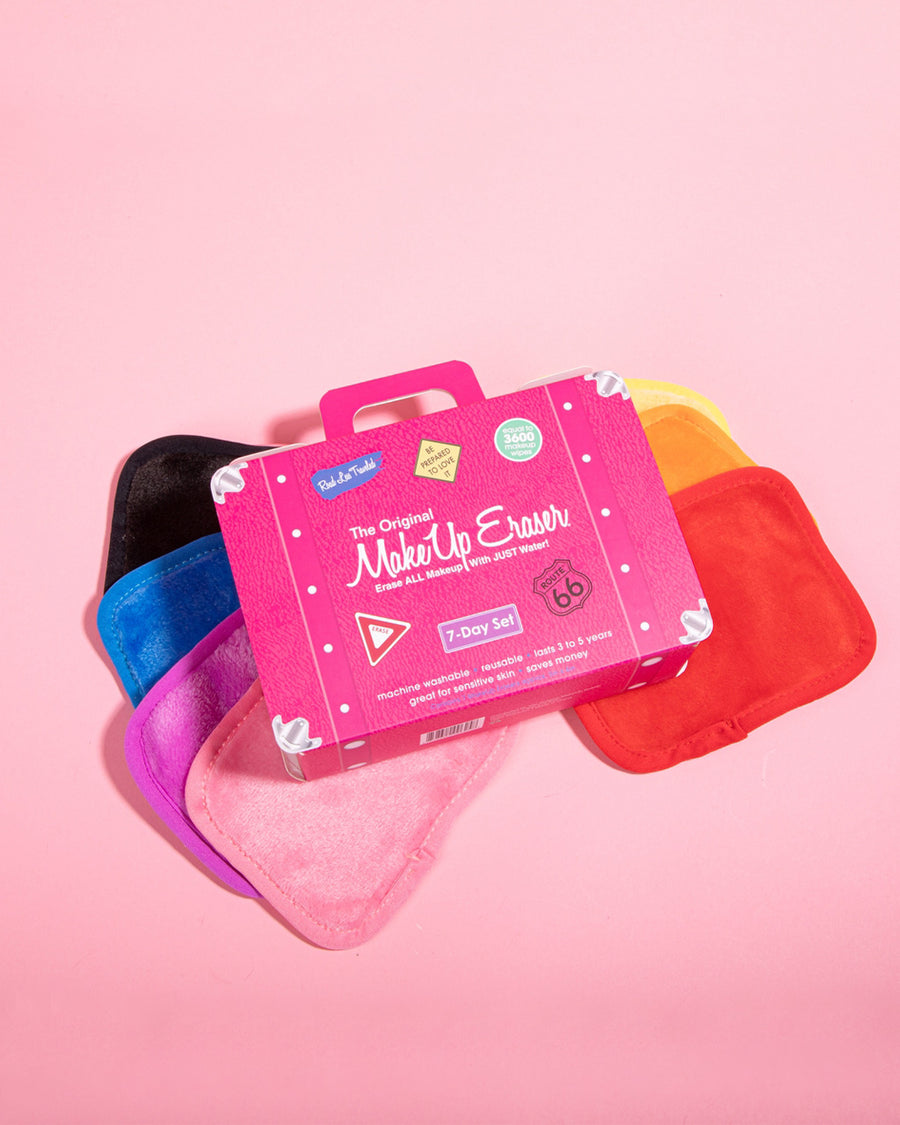 editorial image of set of 7 multicolor makeup eraser clothes and hot pink box shaped like a suitcase