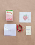 kit includes: embroidery string, needle, fabric, and instructions