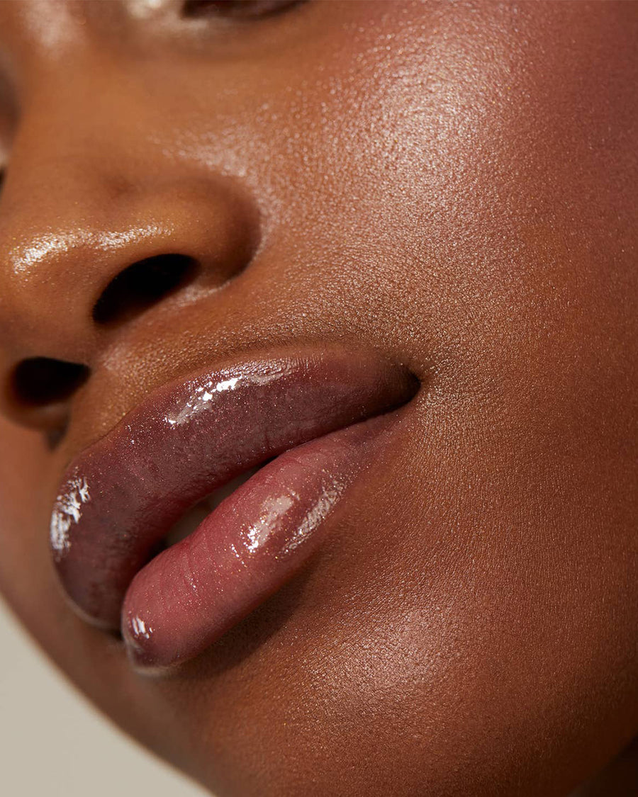 model wearing dark mauve vegan lip gloss