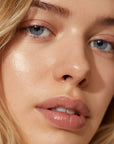 model wearing vegan lip gloss in sparkle brown