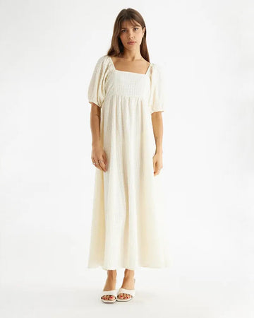 model wearing white lightweight maxi dress with square neck and puff sleeves