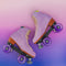 pair of lilac moxi roller skates on pink and purple ombre background