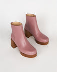 pair of mauve booties with wood stack heel and platform