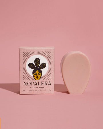pale pink cactus soap bar shown next to pink Nopalera packaging against a pink backdrop