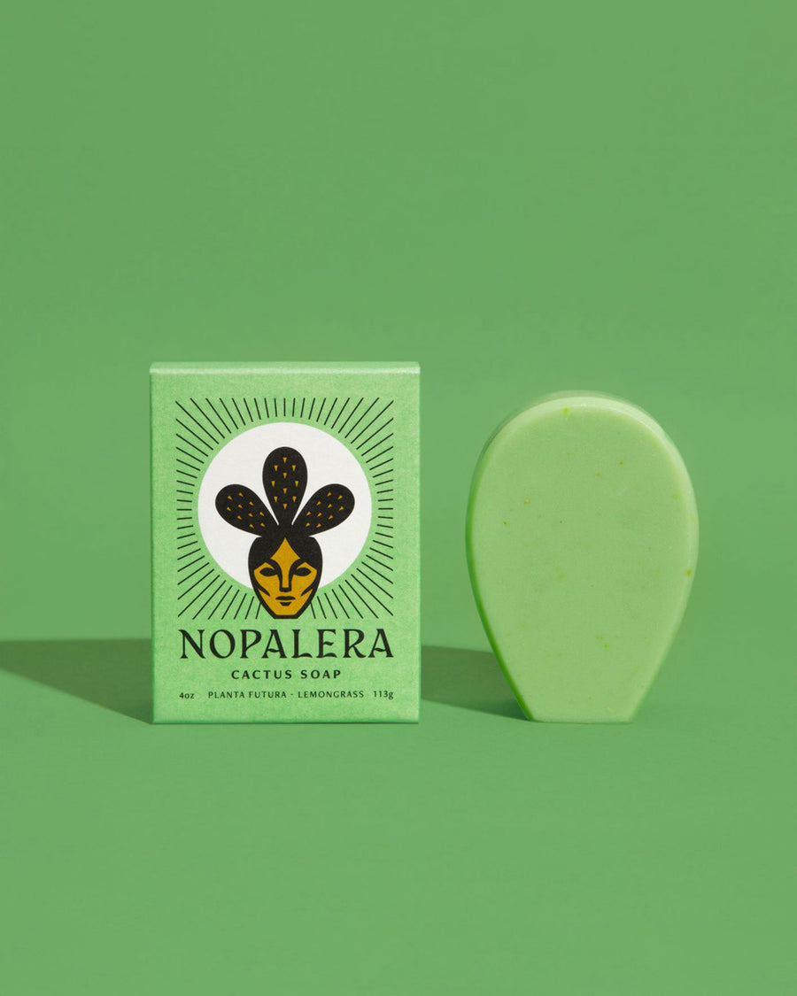 green cactus soap bar shown next to green Nopalera packaging against a green backdrop