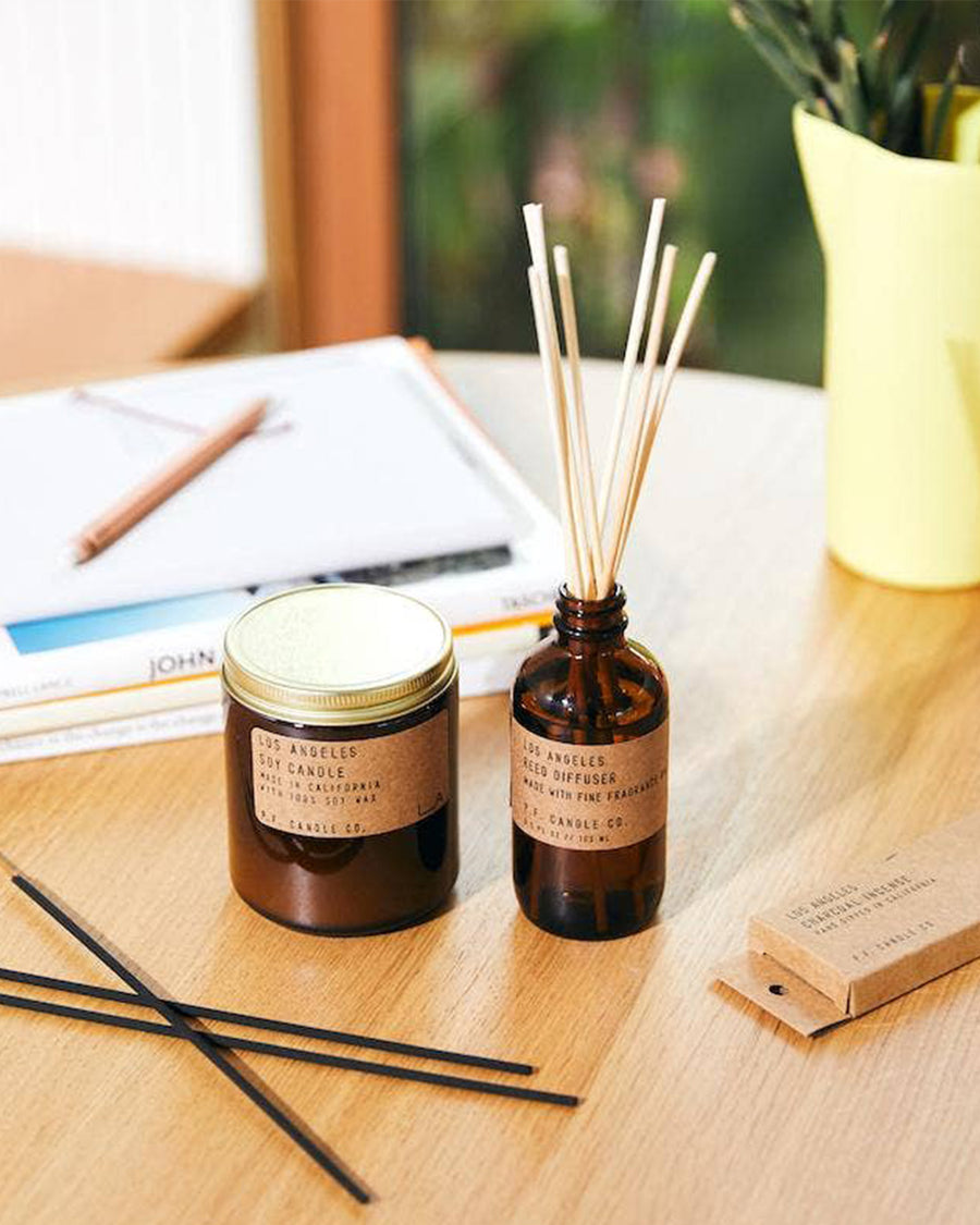 los angeles standard soy candle next to reed diffuser