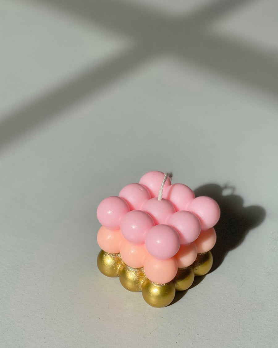 light pink, peach and metallic gold bubble candle