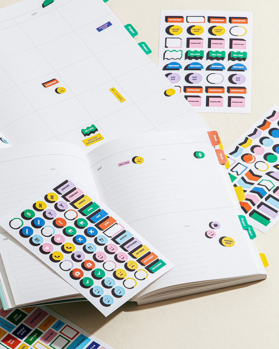 reminder style sticker sheets shown with planner and calendar notebooks