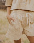 up close of pocket in tan gingham tie shorts