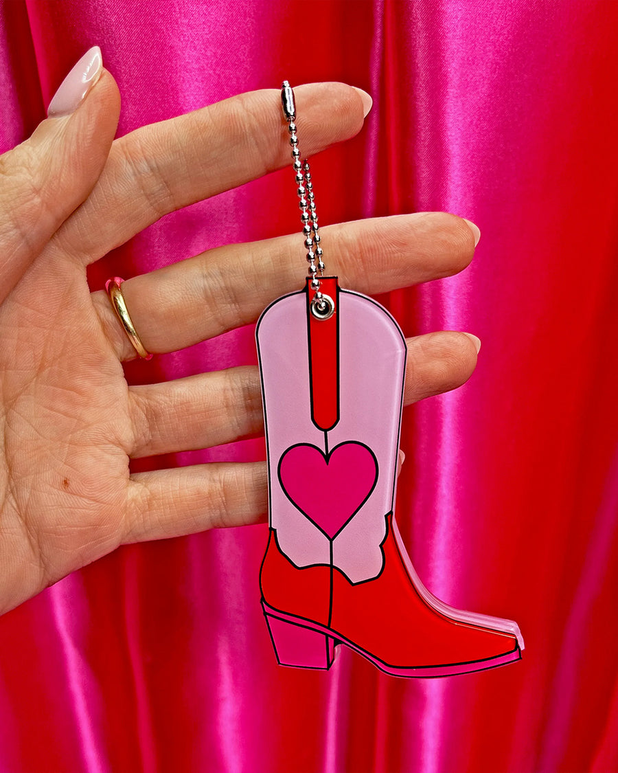  pink cowboy boot to show compact mirror in models hand to show size