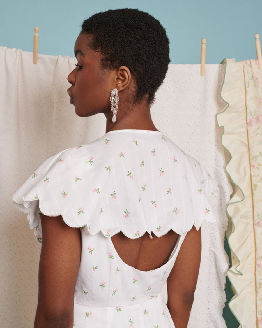 backview of scalloped collar and open back on dainty floral print midi dress