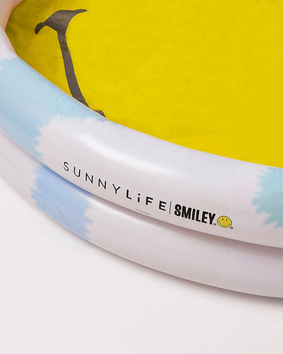 up close of blue and white sides with 'sunnylife smiley' logo