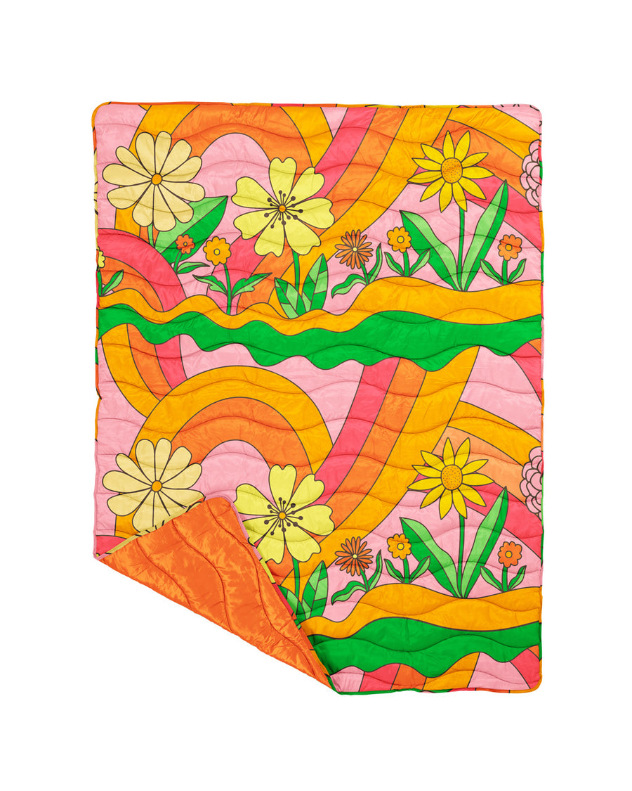 puffy blanket with groovy floral print and orange underside