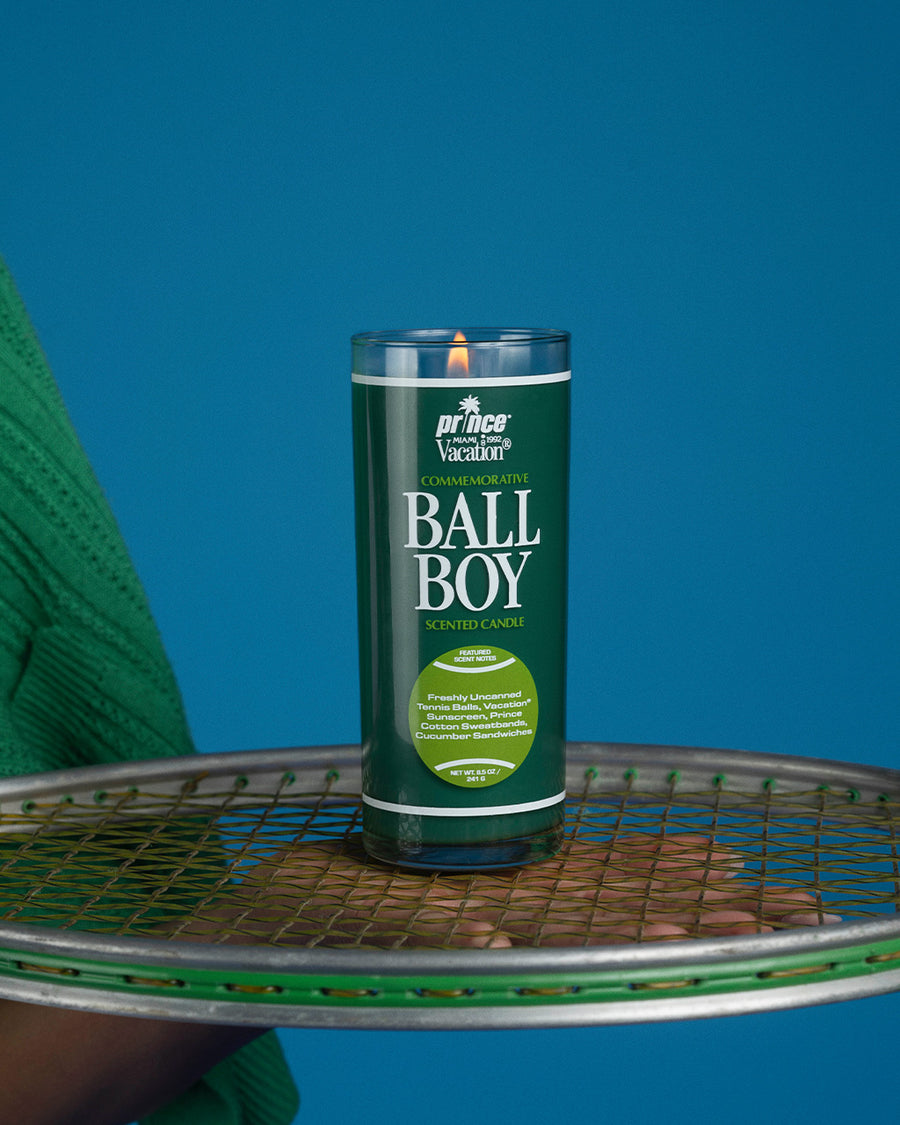 up close of dark green ball boy candle on a tennis racket
