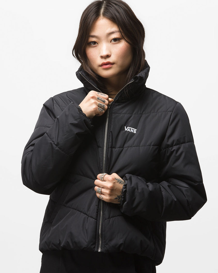 black puffy jacket with small white Vans logo