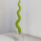 lime green squiggle stick candle in candleholder