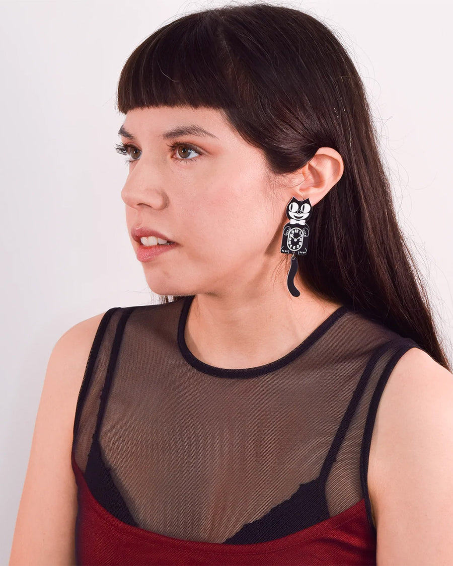 model wearing licensed retro felix cat clock earrings