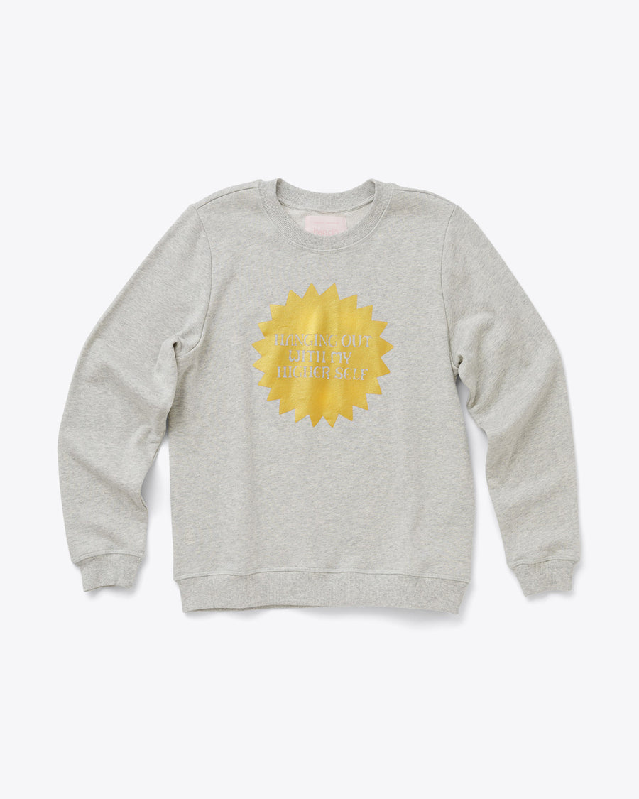 grey balloon sleeve sweatshirt with a gold sun shaped design in the middle and the words hanging out with my higher self