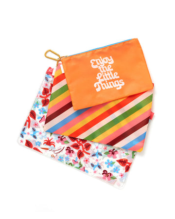 set of three carryall with orange ground and says 'enjoy the little things', diagonal rainbow stripe and clear ground with multicolor floral print