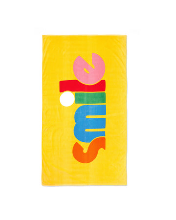 yellow ground rectangle beach towel with multicolor 'smile' in the middle