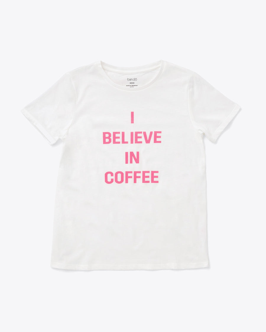 white tee with the words i believe in coffee in pink lettering