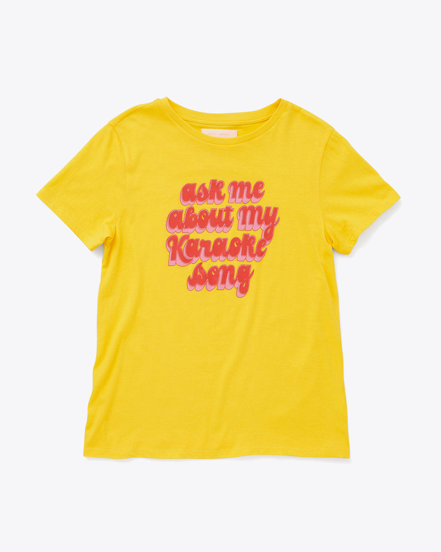 bright yellow tee with the words ask me about my karaoke song in red and pink lettering