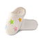 pair of white sherpa feel slippers with pink, blue, green and red stars on them